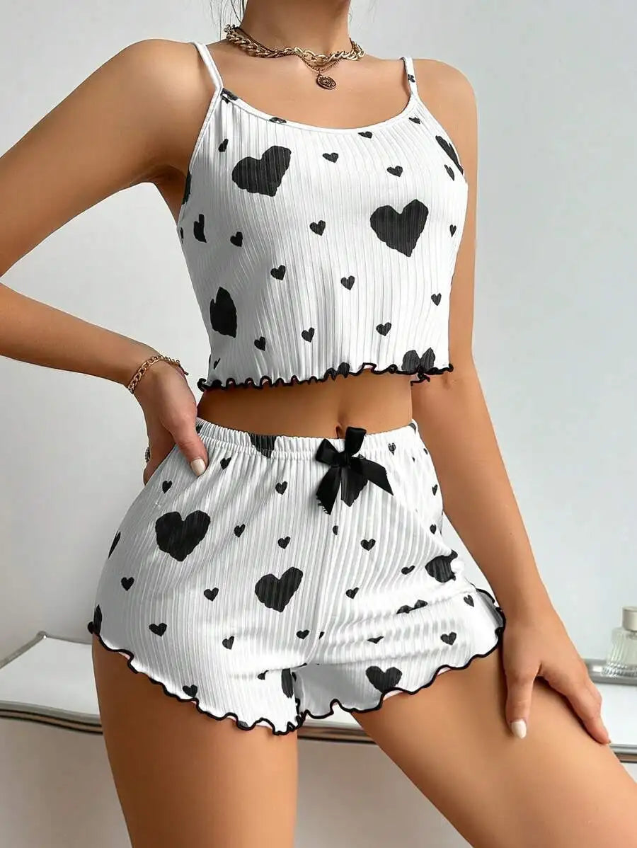 White Women's Pajamas Set - Soft Pajama Set with black hearts and black trim, featuring a sleeveless top and ruffled shorts.