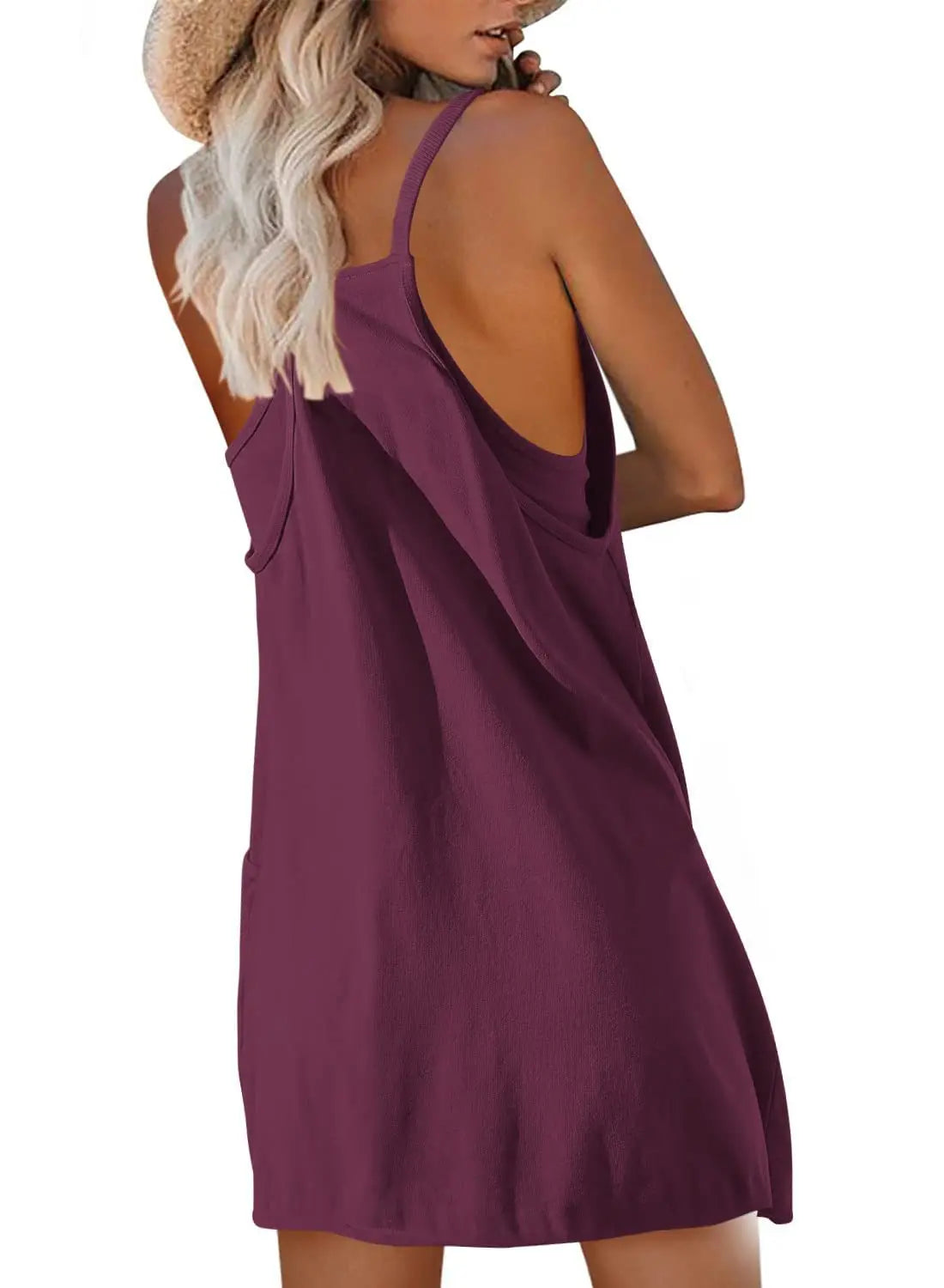 Back view of a woman wearing a breezy, burgundy summer romper, perfect for warm weather activities.