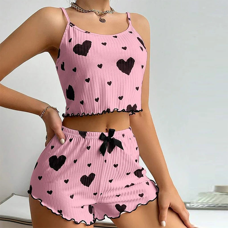 Pink Women's Pajamas Set - Soft Pajama Set with black hearts, featuring a bow accent and ruffled hem for a cute sleepwear look.